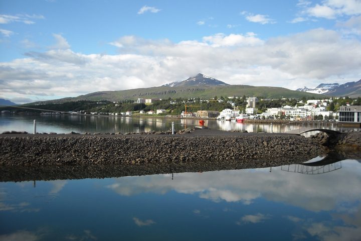 Akureyri waterfront and harbour beneath green hills, photographed in July 2017