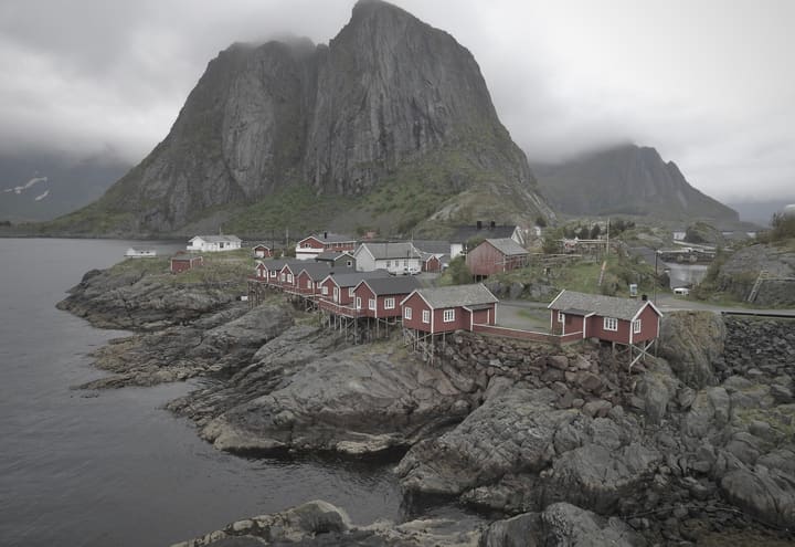 Red rorbuer fishing cabins on Hamnøy below the steep Lofoten mountains