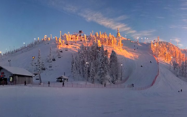 Snow-covered Rukatunturi ski slopes and trees lit by the low December sun in 2014