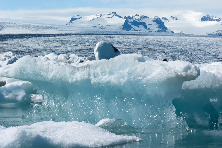 Icebergs on Jokulsarlon glacier lagoon with a distant glacier, photographed in May 2006